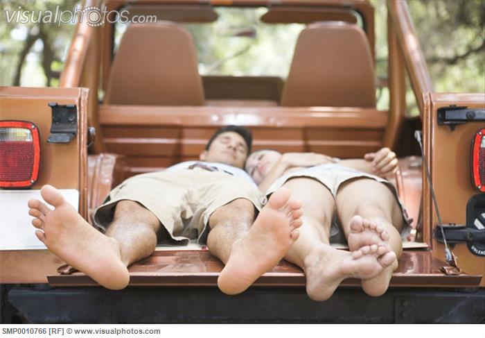 barefoot_couple_sleeping_in_a_jeep_SMP0010766.jpg